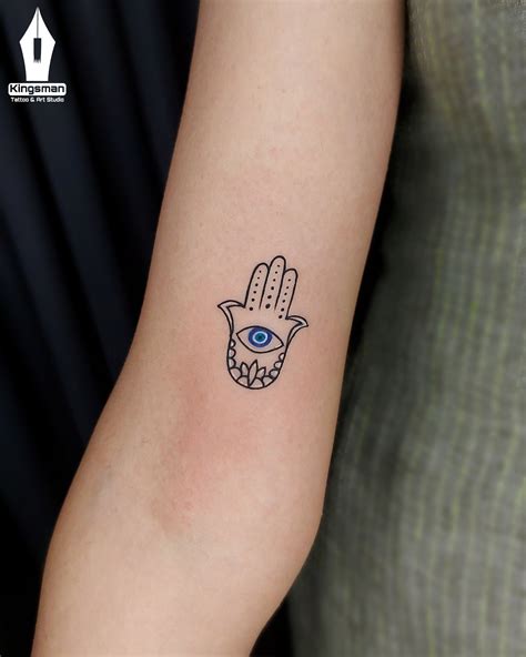 tiny evil eye tattoo